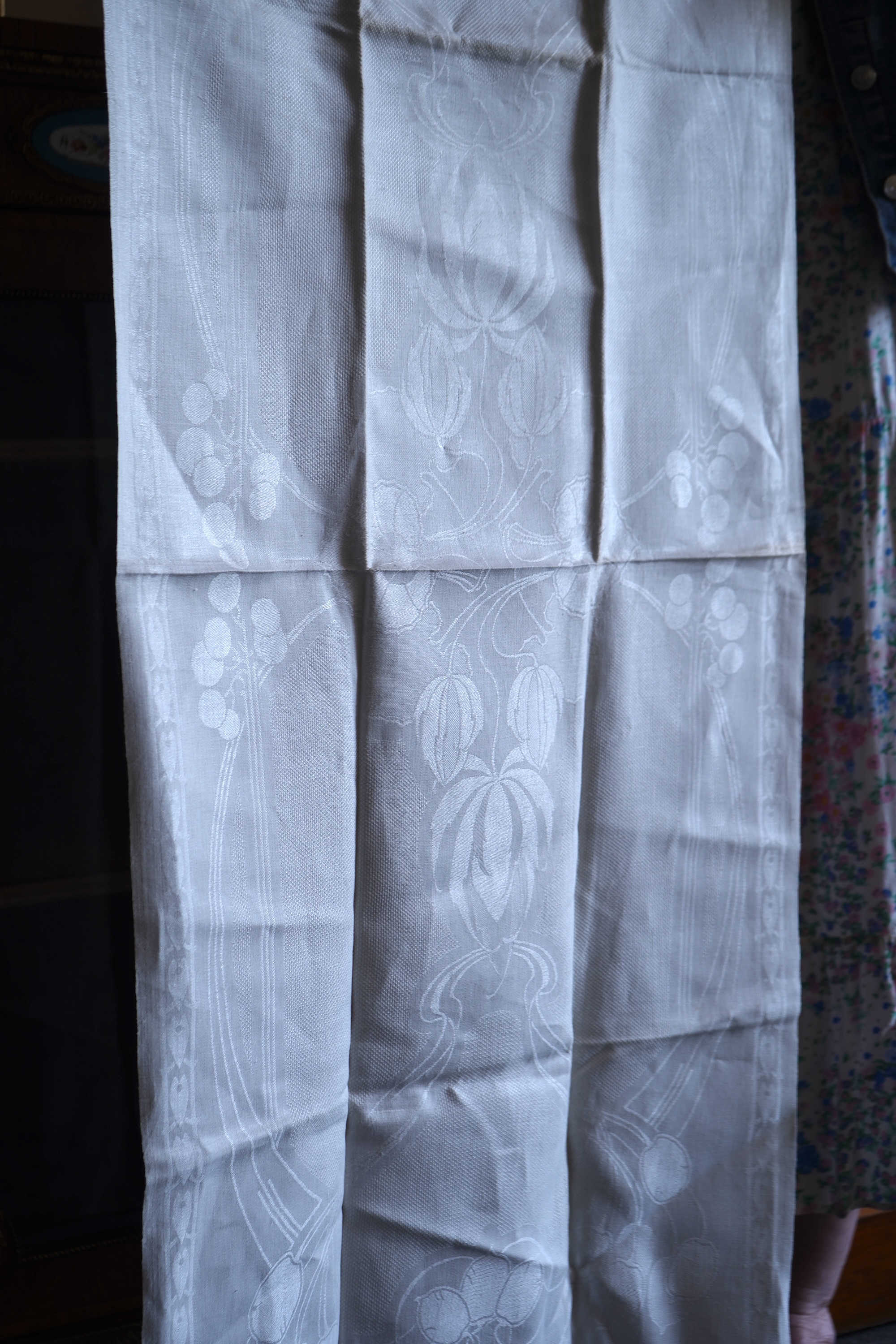 A set of four large Art Nouveau, unused white damask woven hand towels. The pattern having strong Archibald Knox and Walter Crane design elements; with trailing Honesty seeds and Tulip flower heads, these motifs much use